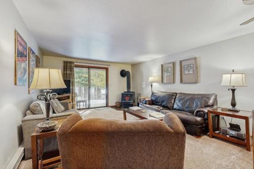 a living room with a couch and a table at Aspen Village Golf Course Condo - Fairways 71 in McCall