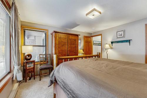 a bedroom with a bed and a desk and a window at Aspen Village Golf Course Condo - Fairways 71 in McCall