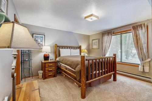 a bedroom with a bed and a desk and a window at Aspen Village Golf Course Condo - Fairways 71 in McCall