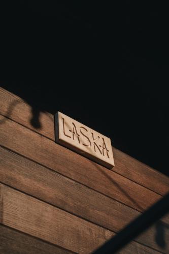 a wooden table with a sign on top of it at Laska House in Pylypets