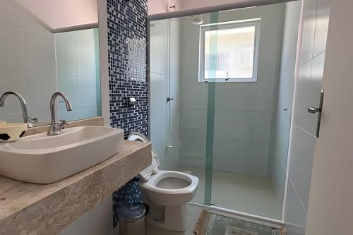 Casa c/ piscina em Cond, Boraceia - SP في بوراسيا: حمام مع حوض ومرحاض ودش