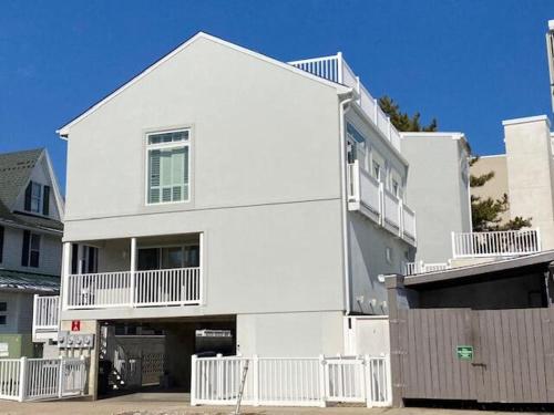 a white house with a fence in front of it at Olive avenue 1a in Rehoboth Beach