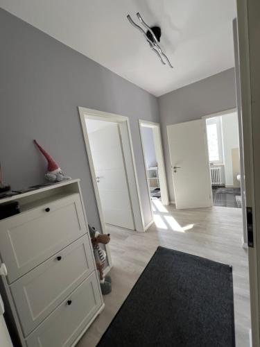 a room with a white dresser and a black rug at Renoviertes Appartment mit 2 Schlafzimmern in Vianden