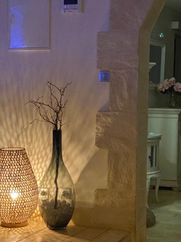 a glass vase sitting on a table next to a lamp at Villa Tropiraizet in Les Abymes