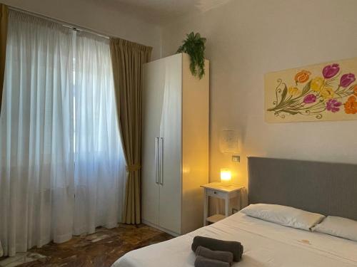 a bedroom with a bed and a large window at Il Giardino Di Flora con Piscina & Jacuzzi in Lecce