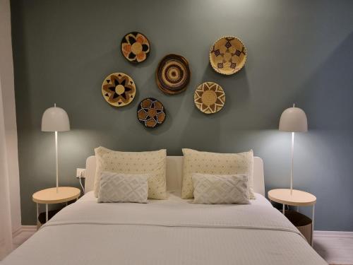 a bedroom with a bed with four plates on the wall at Central Location 2 Bedroom Apt in Antalya