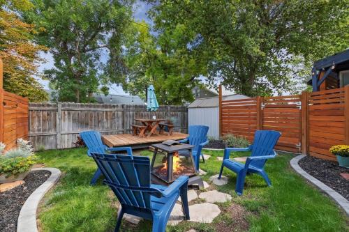 a backyard with a table and chairs and a fire pit at #StayInMyDistrict Historic Charming Bungalow in Twin Falls