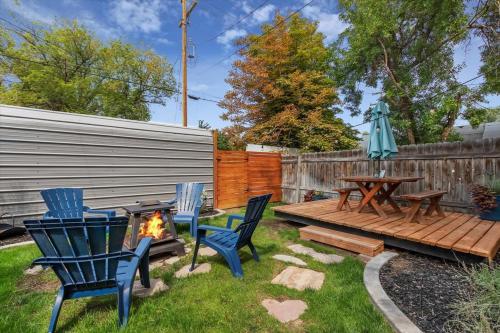 a backyard with a table and chairs and a fire pit at #StayInMyDistrict Historic Charming Bungalow in Twin Falls