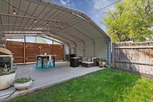 a patio with a table and a wooden fence at #StayInMyDistrict Historic Charming Bungalow in Twin Falls