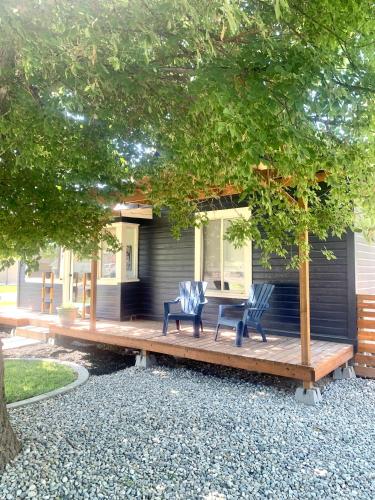 a house with two chairs and a table on a deck at #StayInMyDistrict Historic Charming Bungalow in Twin Falls
