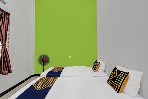 Ένα ή περισσότερα κρεβάτια σε δωμάτιο στο Hotel O Lucky Guesthouse