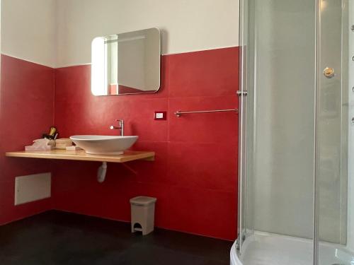 a red bathroom with a sink and a shower at Il Giardino Di Flora con Piscina & Jacuzzi in Lecce