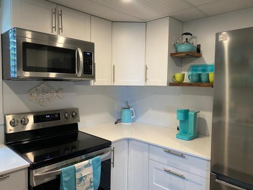 a kitchen with a stove and a microwave at Passage view in Campbell River
