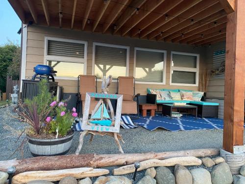 a house with a patio with a table and a chair at Passage view in Campbell River