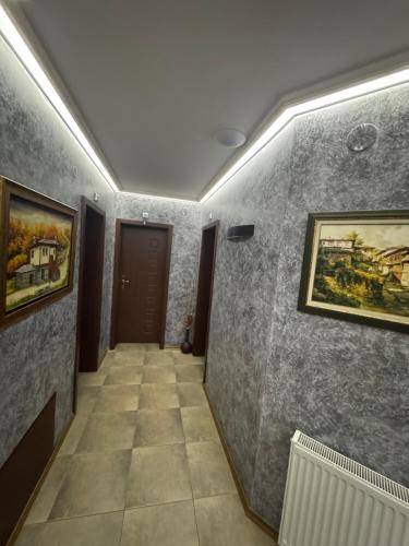 a hallway with paintings on the walls of a room at Family Hotel Eterno in Tsigov Chark