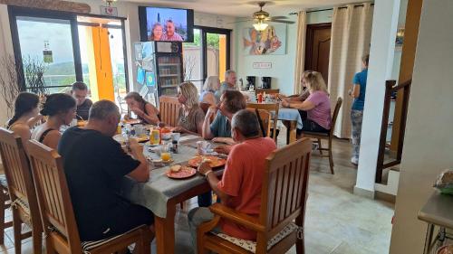 a group of people sitting at a table in a restaurant at Boca Chica Bay Eco Lodge in Boca Chica