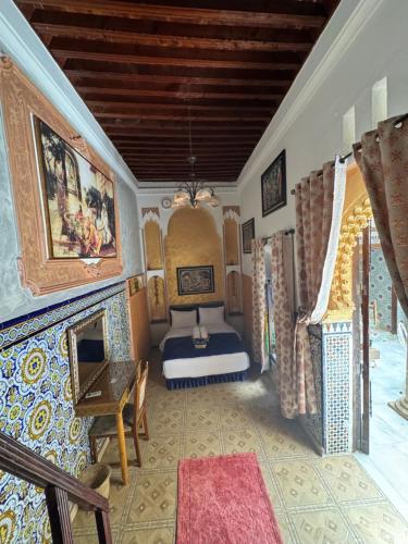 a room with a bedroom with a bed and a fireplace at RIAD ESMERALDA By Dar Ouezzani in Rabat