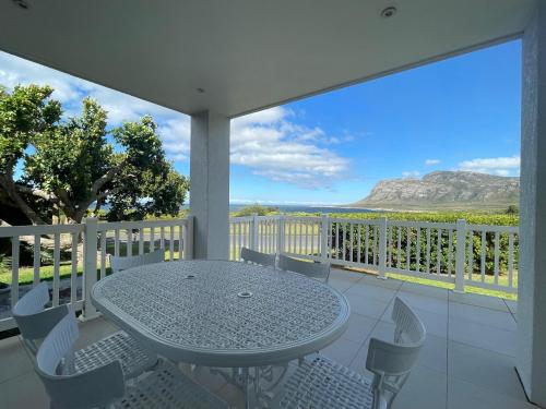 a table and chairs on a balcony with a view at Views galore in Kleinmond in Kleinmond