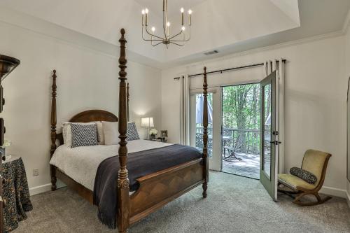 a bedroom with a bed and a large glass door at Adventures at Big Canoe - Spacious Cabin Rental in Big Canoe - Serene Nature Views, Cozy Fireplace, Spacious Decks, Walking Dist in Afton