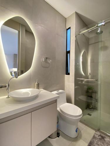 a bathroom with a toilet and a sink and a shower at Amaru in Loja