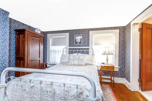 a bedroom with a bed with blue wallpaper at Briarstone Inn Unit 1 in Galena