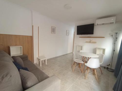a living room with a couch and a table at Benidorm Center Centro in Benidorm