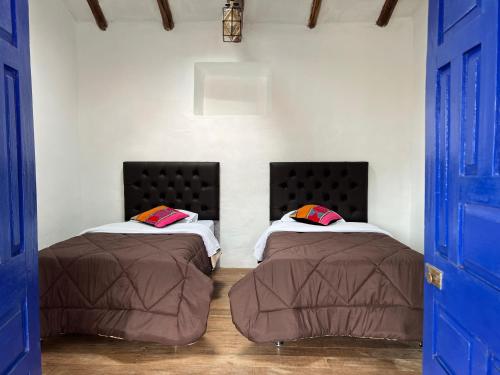 Postel nebo postele na pokoji v ubytování Auquis Hostel