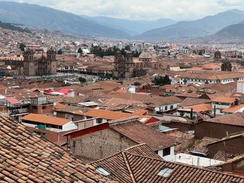 a view of a city with buildings and roofs at Auquis Hostel in Cusco