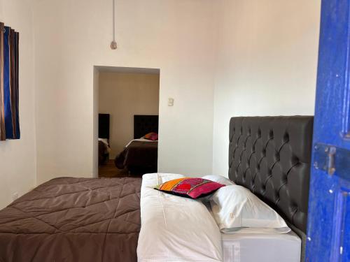 a bedroom with a bed in a room at Auquis Hostel in Cusco
