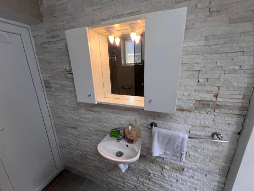 a bathroom with a sink and a mirror at Apartments and bungalows vila Dalibor in Nin