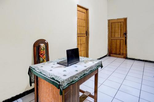 a laptop computer sitting on a table in a room at Hotel O Nurul Homestay Syariah in Gresik