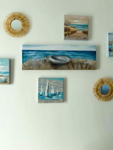 a wall with four pictures of boats on it at Vistamare Oltremare in San Cataldo
