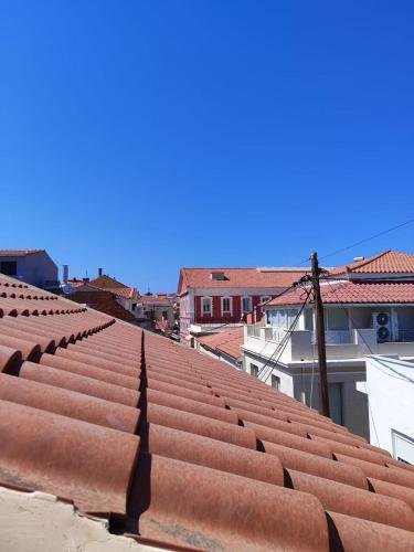 a view from the roof of a building with red roofs at Cosy Nest Apartment in the Heart of Samos in Samos