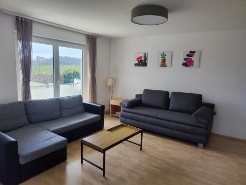 a living room with a couch and a coffee table at Gemütliche 2,5- Zimmer- Wohnung am Wasserturm in Rottweil in Rottweil
