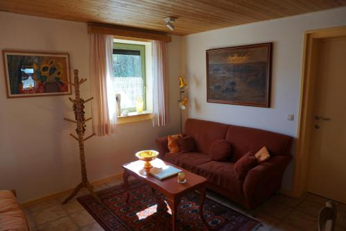 a living room with a couch and a table at La petite source in Florenville
