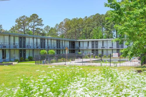 an exterior view of a building with a yard at Masters Inn Selma Smithfield I-95 By OYO in Selma
