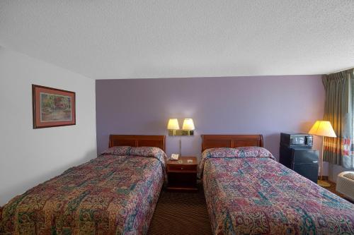 a hotel room with two beds in a room at Masters Inn Selma Smithfield I-95 By OYO in Selma