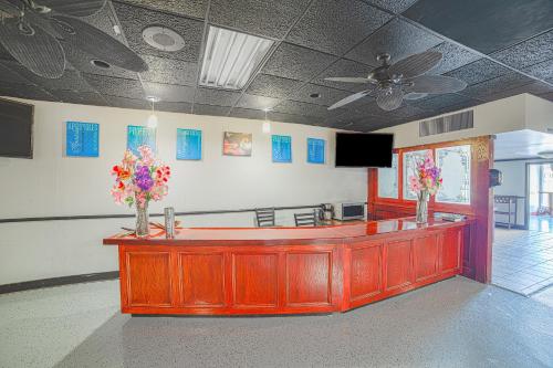a lobby with a reception desk with flowers on it at Masters Inn Selma Smithfield I-95 By OYO in Selma