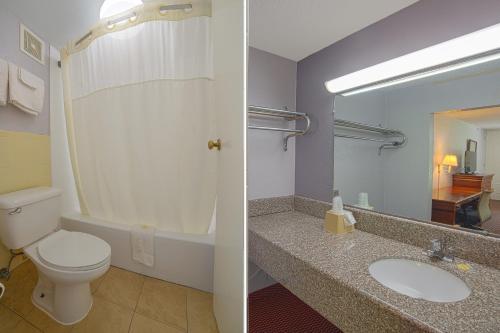 a bathroom with a toilet and a sink at Masters Inn Selma Smithfield I-95 By OYO in Selma