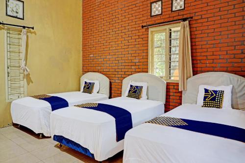 Ένα ή περισσότερα κρεβάτια σε δωμάτιο στο Hotel O Griyo Werdiningsih