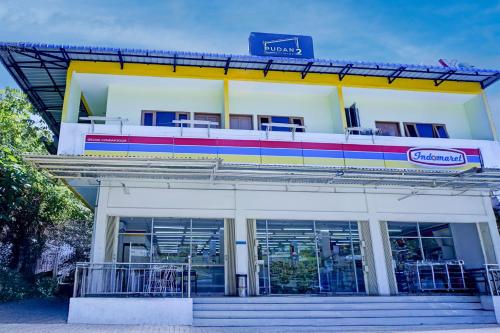 a building with a train on top of it at Hotel O Parapat Near Dermaga Ajibata Formerly Pudan Residence 2 in Parapat