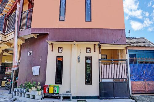 a building with a door on the side of it at OYO Life 92353 Purnama Syariah Guest House in Blitar