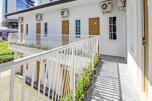 a white house with a white railing at Collection O 92363 Kp Inn in Yogyakarta