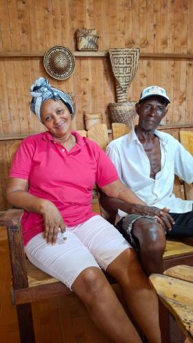 a woman sitting next to a man sitting on a chair at Posada La Veranera in Arusí