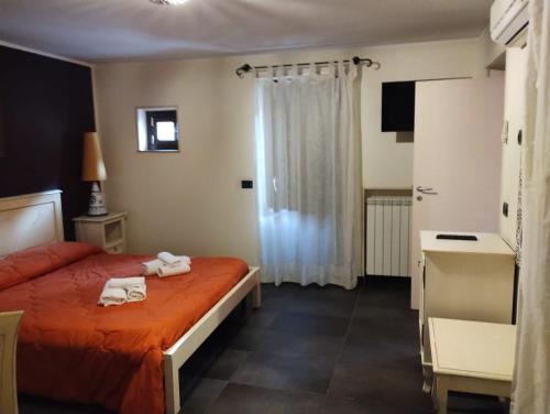 a hotel room with a bed with towels on it at Locanda Re Ruggero in Monreale