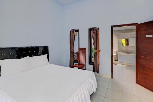 Ένα ή περισσότερα κρεβάτια σε δωμάτιο στο Hotel O Mustika