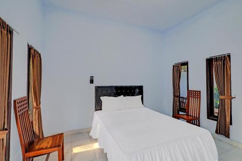 Ένα ή περισσότερα κρεβάτια σε δωμάτιο στο Hotel O Mustika