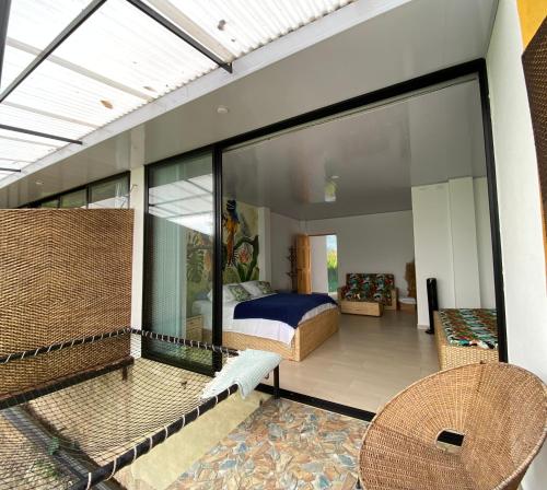 a bedroom with a bed and a balcony at Tambo Eco Hotel in La Vega