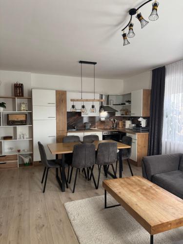 a kitchen and dining room with a table and chairs at Wohnungen Beshi Niederthalheim in Vöcklabruck