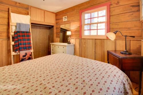 a bedroom with a bed and a window at Cozy Cabin with Private Dock on Fifth Crow Wing Lake in Nevis